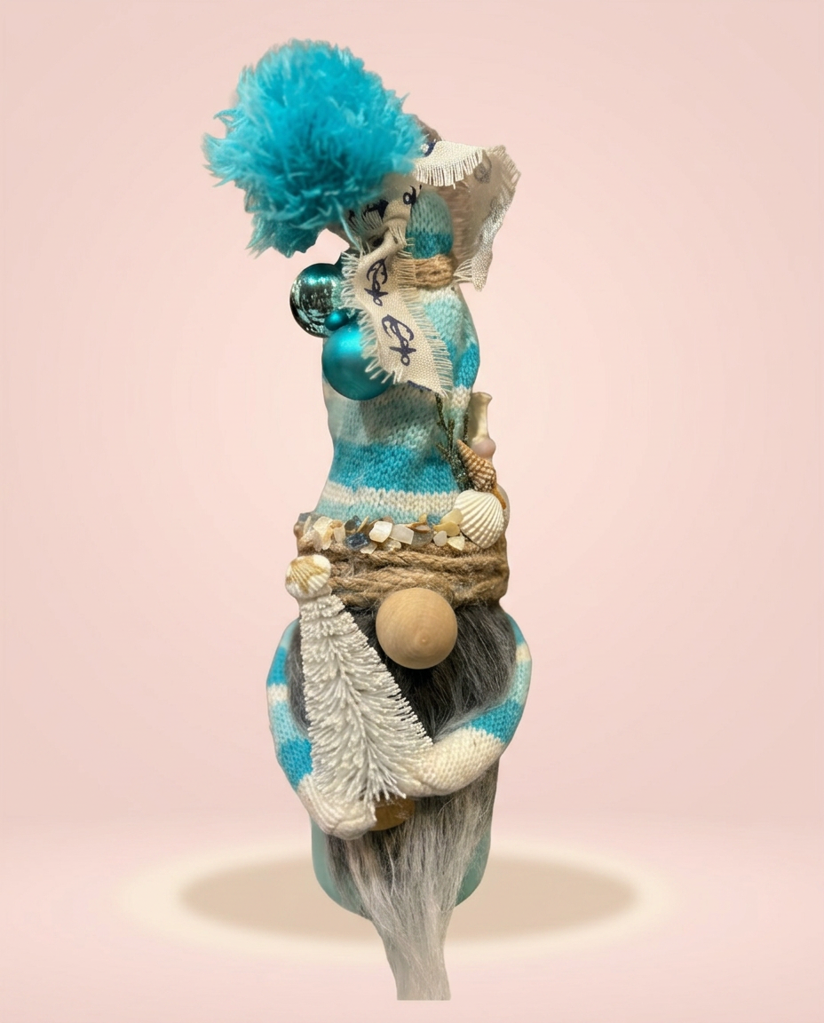 Coastal blue gnome craft with shells on a blush background